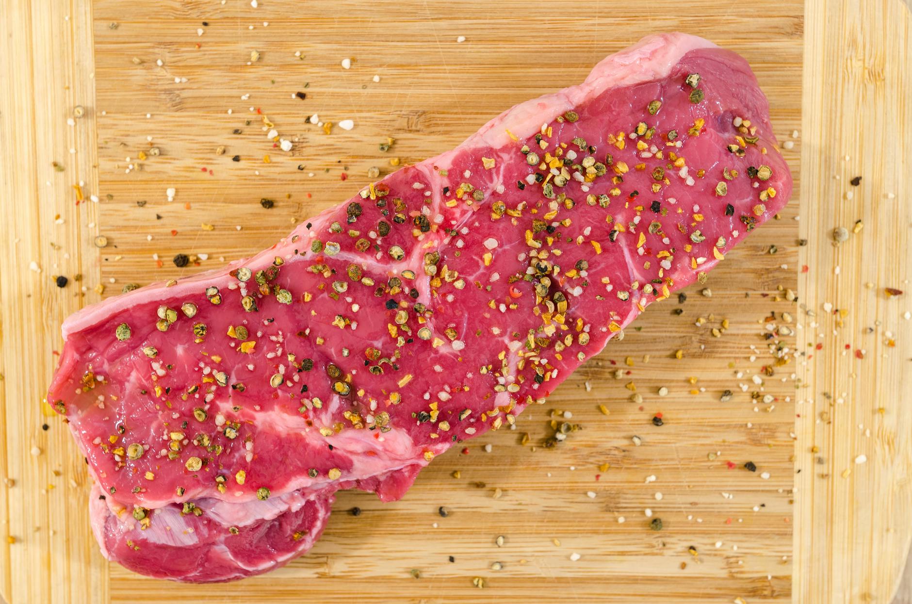 raw meat on beige wooden surface
