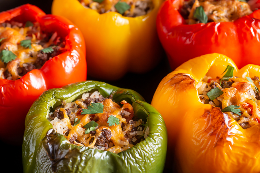 Red yellow and green stuffed bell pepper roasted until caramelized.